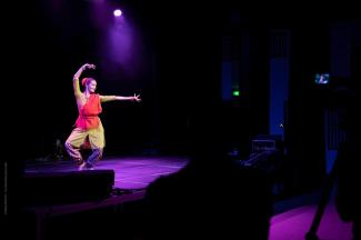 Photo d'une danseuse indienne en mouvement sur scène lors des 10 ans de la Maison de la recherche.